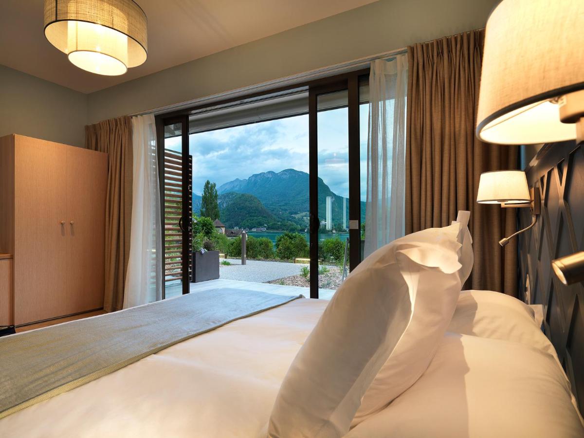Un ou plusieurs lits dans un hébergement de l'établissement Hôtel Beau Site Talloires B SPA
