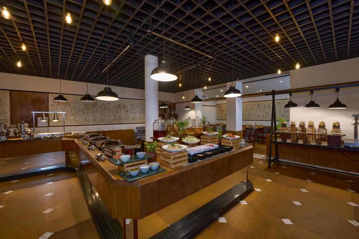 a large kitchen with a buffet in a restaurant at Casino Hotel - CGH Earth, Cochin in Cochin