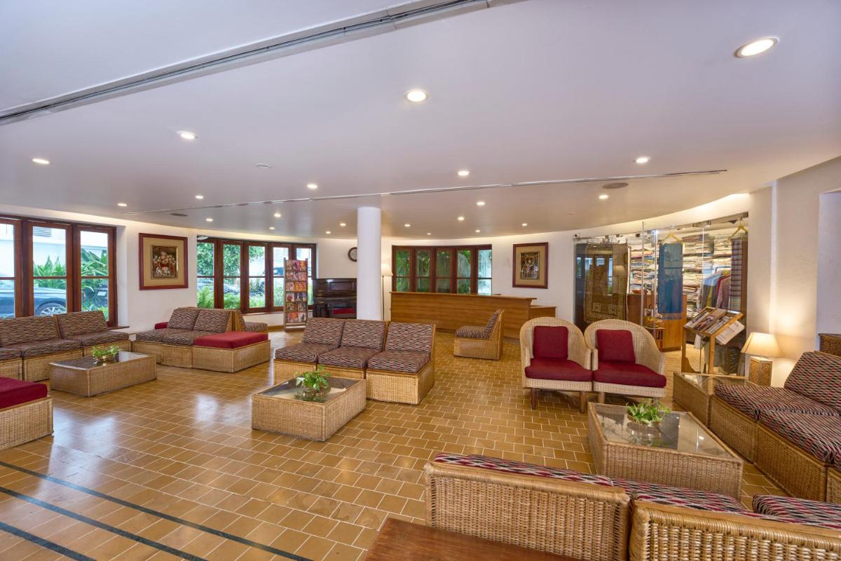 a lobby with couches and chairs in a building at Casino Hotel - CGH Earth, Cochin in Cochin