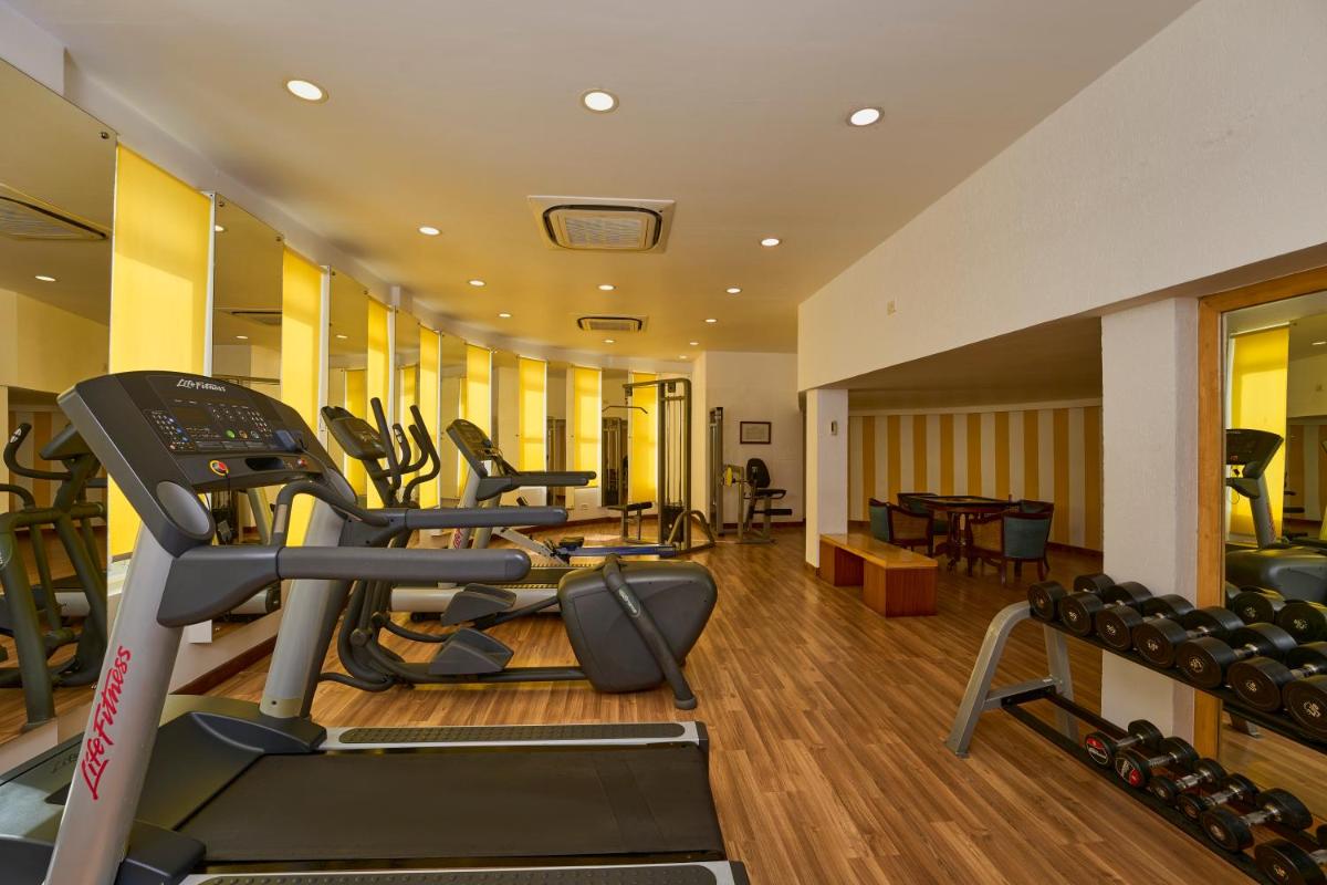 a gym with cardio equipment in a hotel room at Casino Hotel - CGH Earth, Cochin in Cochin