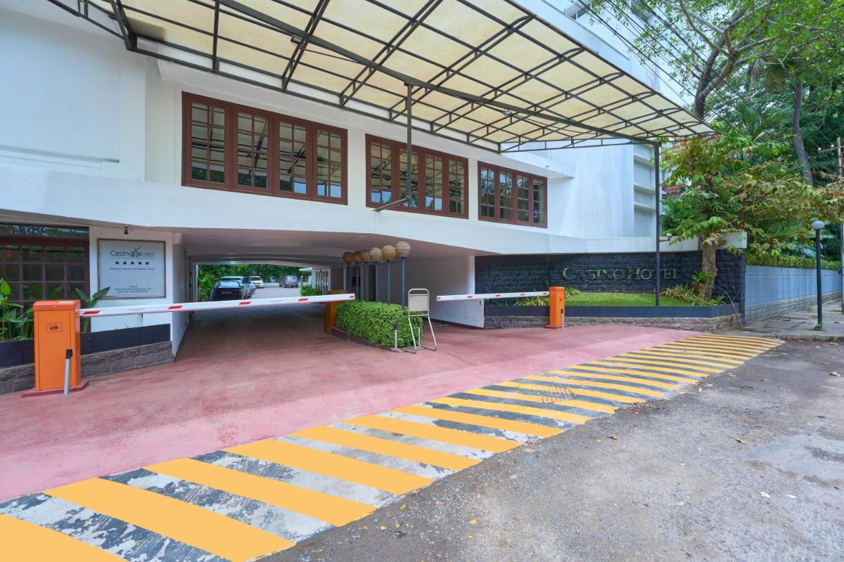 a building with yellow and white stripes on the ground at Casino Hotel - CGH Earth, Cochin in Cochin