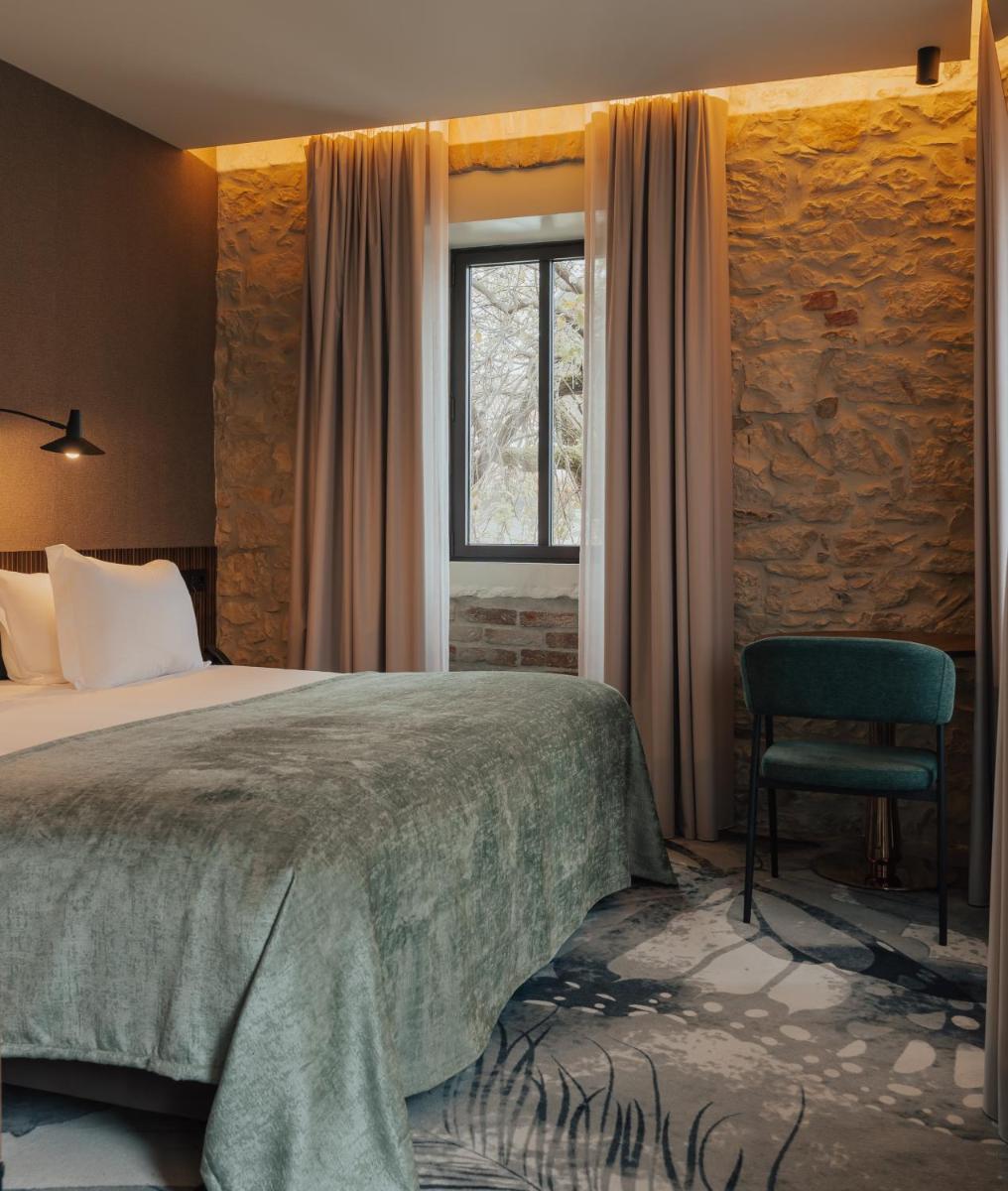 Uma cama ou camas num quarto em Hotel Leiriartem by Grupo Quinta dos Lagos