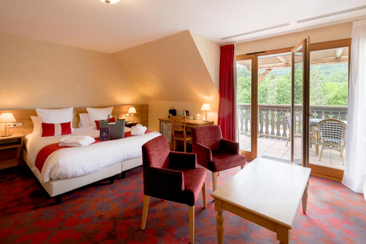 Un ou plusieurs lits dans un hébergement de l'établissement Les Violettes Hotel & Spa