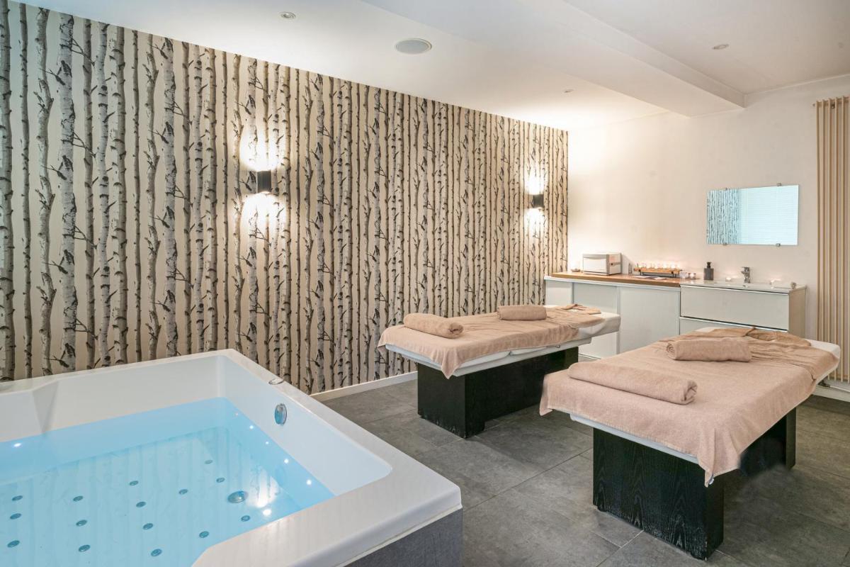 Un ou plusieurs lits dans un hébergement de l'établissement Domaine de Joinville & Spa