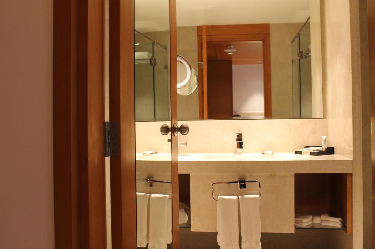 a bathroom with a sink and a mirror at Mercure Hyderabad KCP Banjara Hills, An Accor Hotel in Hyderabad