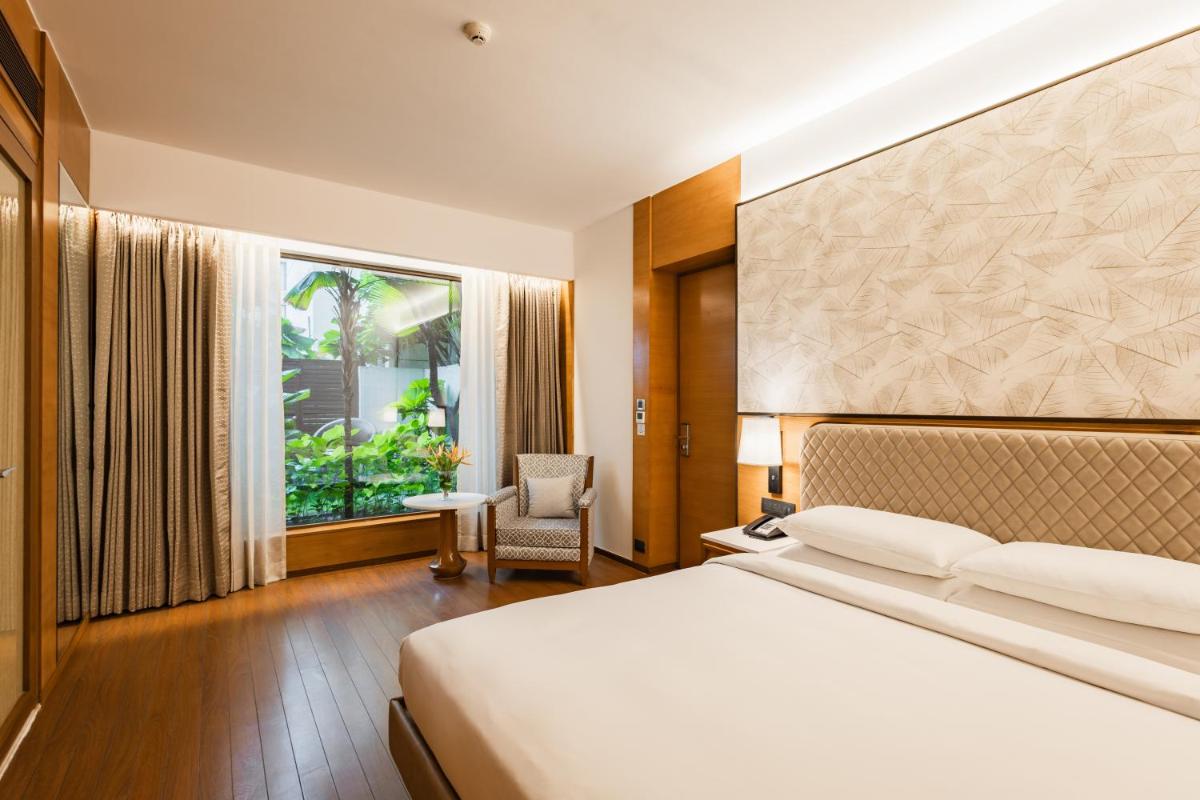 a hotel room with a bed and a window at Hyatt Pune in Pune