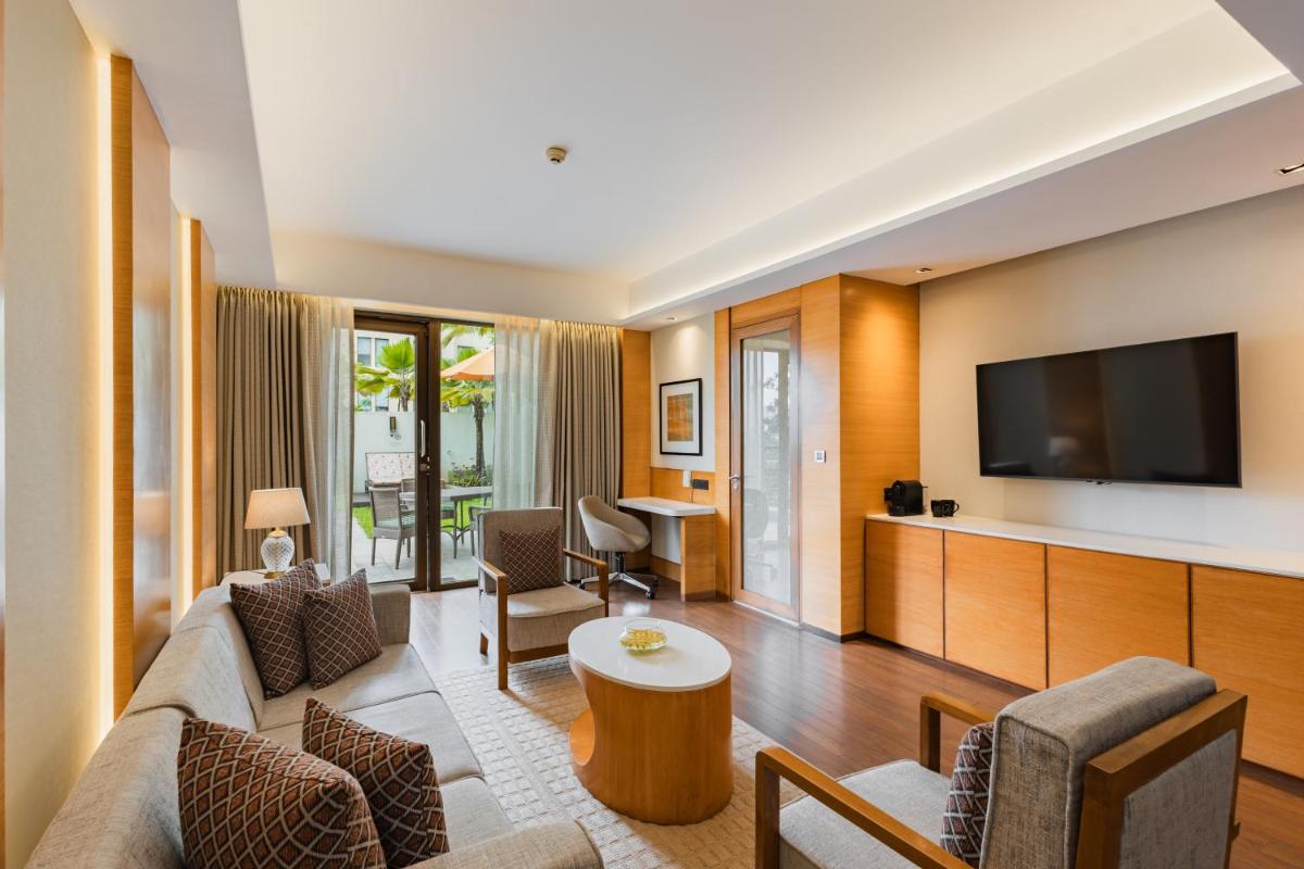a living room with a couch and a tv at Hyatt Pune in Pune