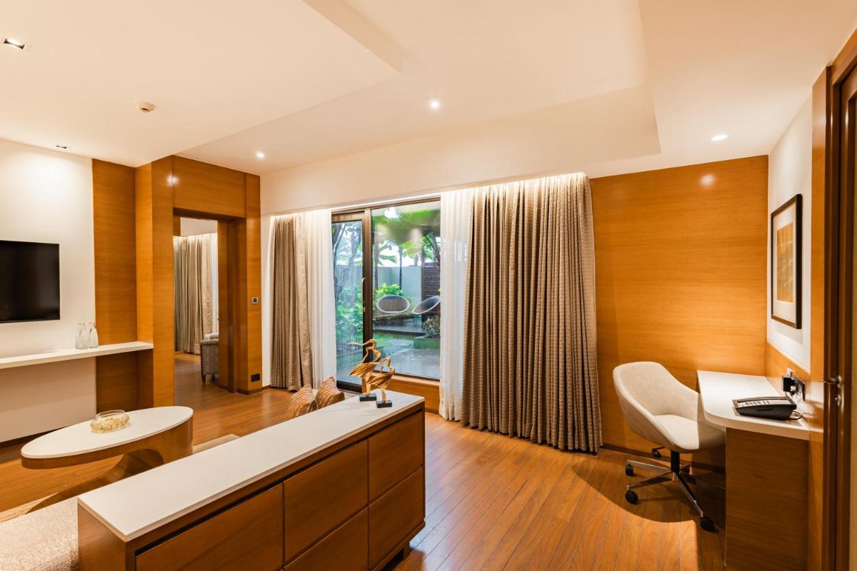 a large living room with a desk and a chair at Hyatt Pune in Pune