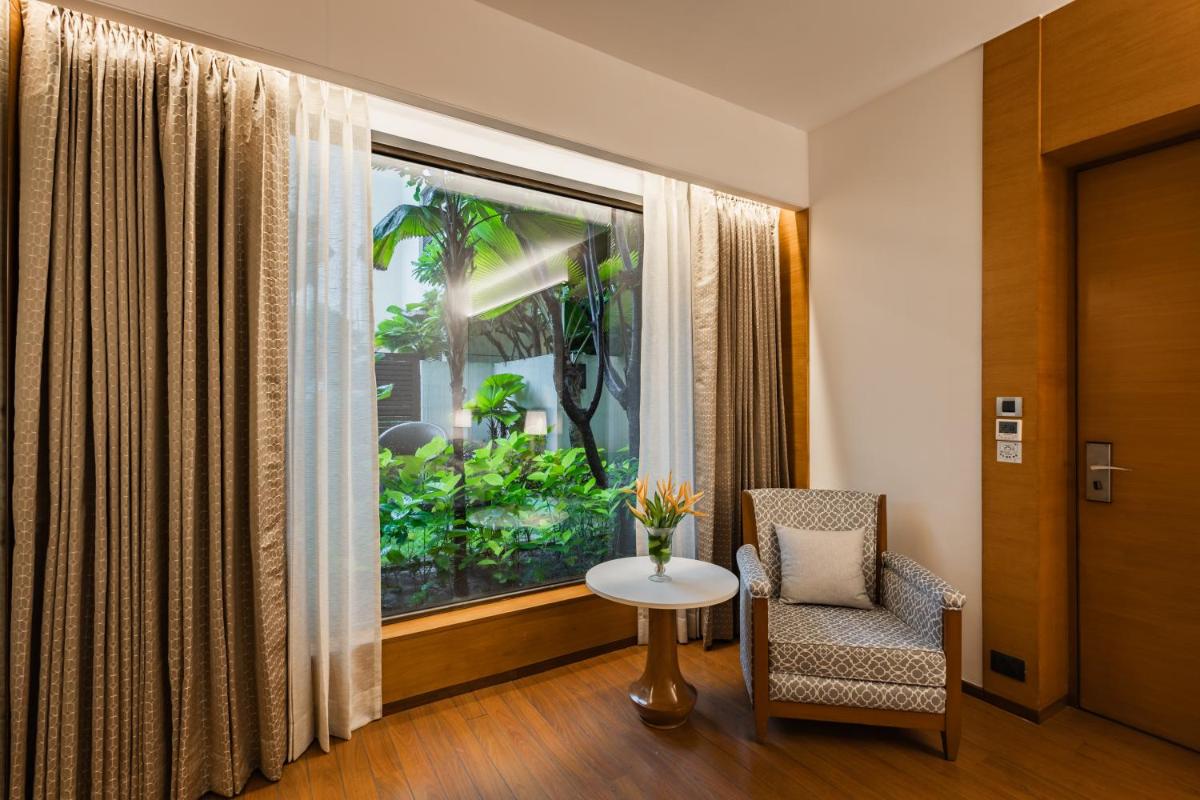 a room with a window with a table and a chair at Hyatt Pune in Pune