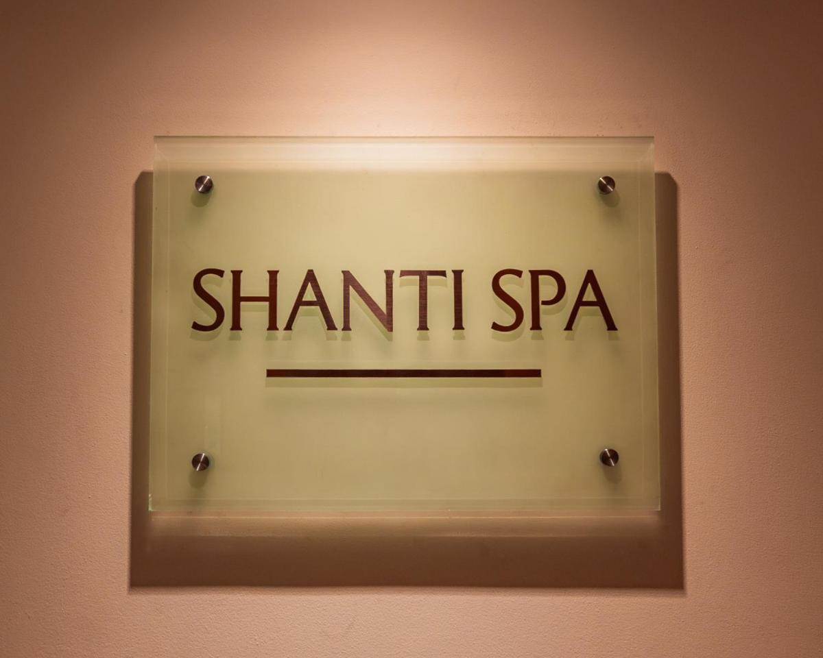 a sign for a shantini spa on a wall at Hyatt Pune in Pune