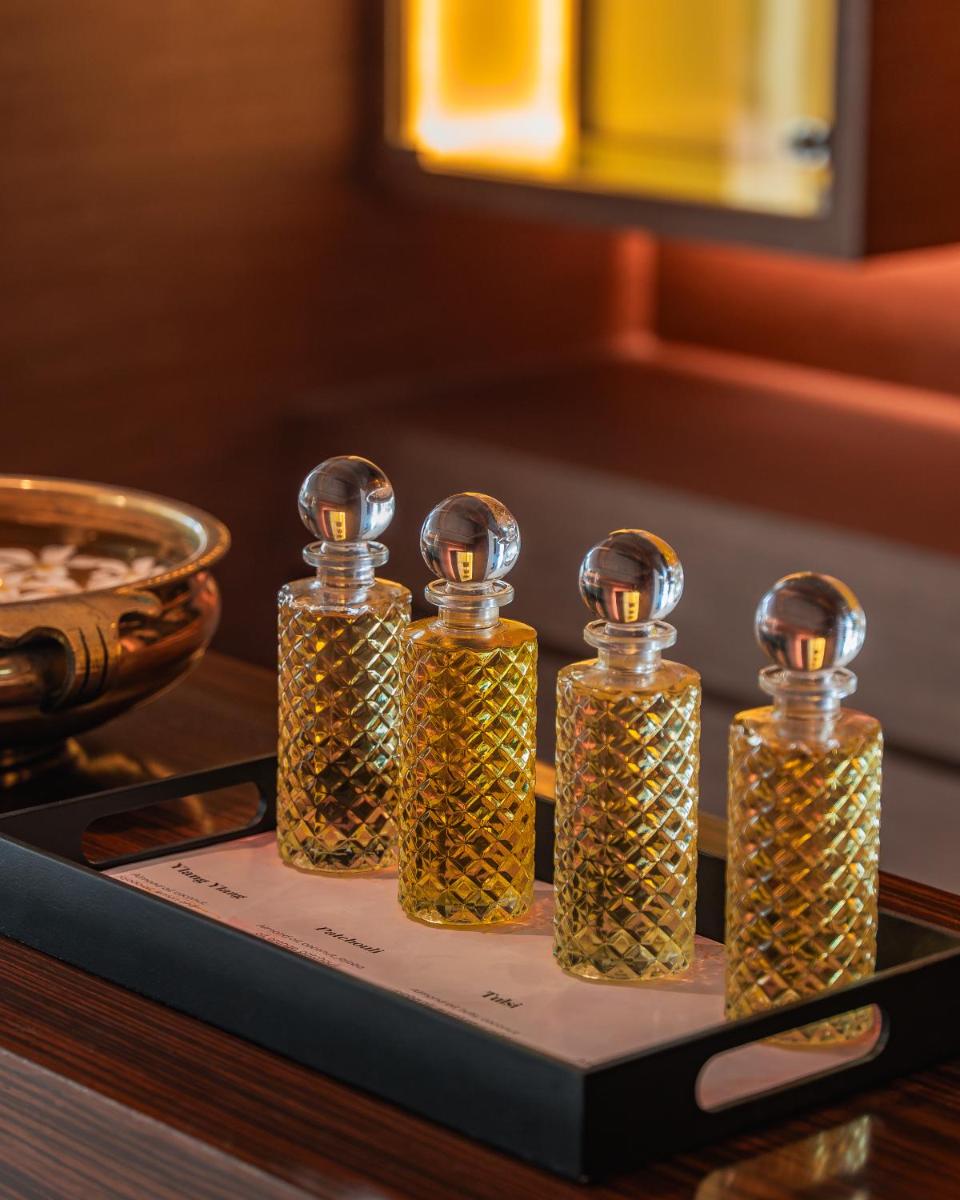 three bottles of oil on a tray on a table at Hyatt Pune in Pune