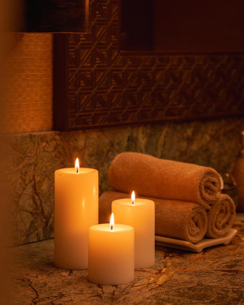 a group of candles sitting on a counter with towels at Hyatt Pune in Pune