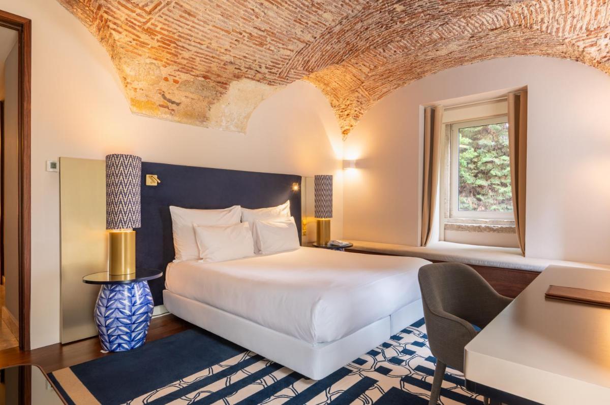 Uma cama ou camas num quarto em Palácio do Governador - Lisbon Hotel & Spa