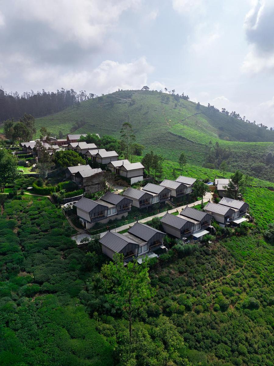 an aerial view of a village on a hill at WelcomHeritage Ayatana Ooty in Ooty