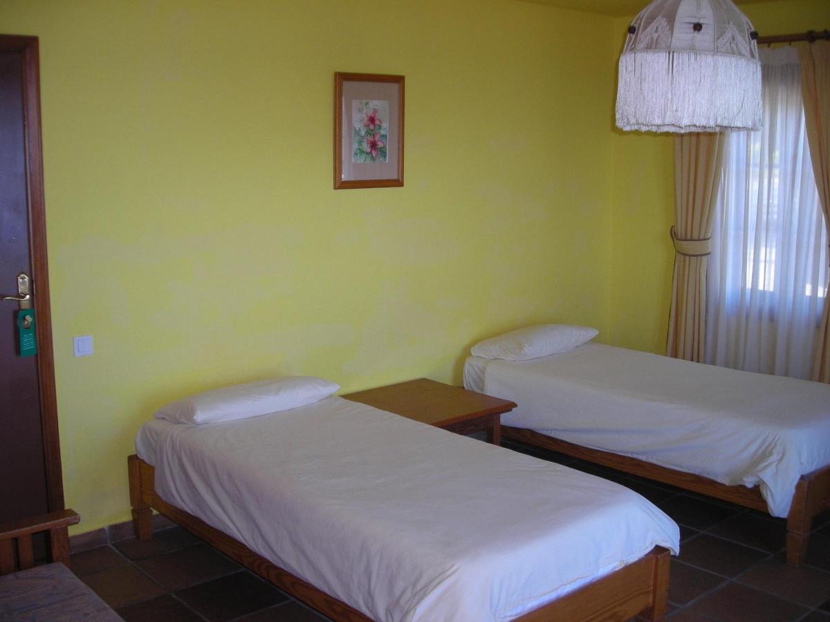 Cama o camas de una habitación en Hotel La Palma Romántica