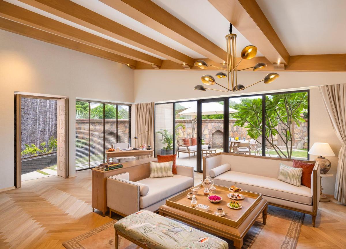 a living room with a couch and a table at Taj Aravali Resort & Spa Udaipur in Udaipur