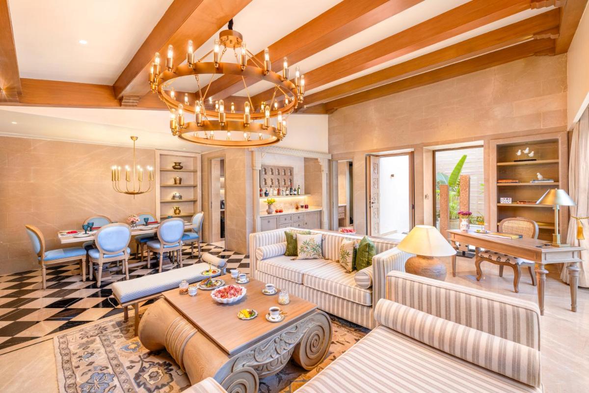 a living room with a couch and a table at Taj Aravali Resort & Spa Udaipur in Udaipur