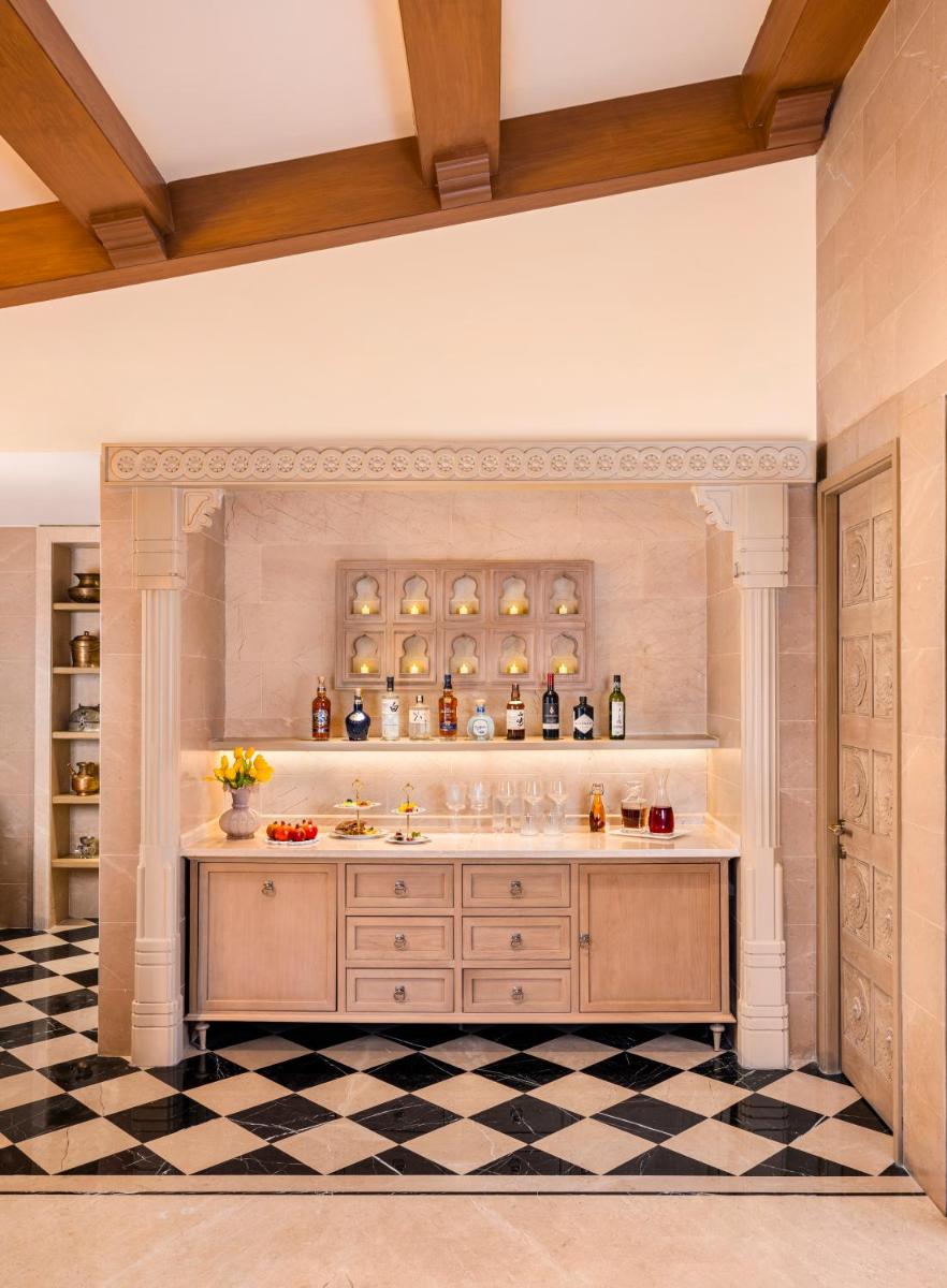 a bathroom with a sink and a checkered floor at Taj Aravali Resort & Spa Udaipur in Udaipur