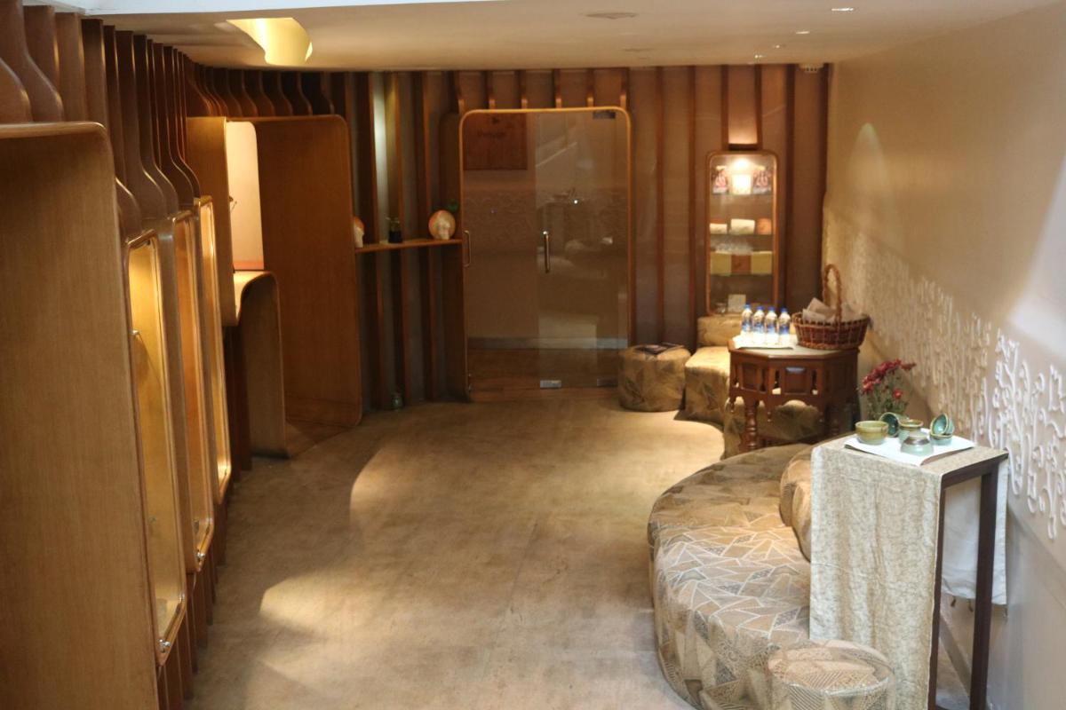 a living room with a large bed and a table at Taj MG Road Bengaluru in Bengaluru a living room with a large bed and a table at Taj MG Road Bengaluru in Bengaluru