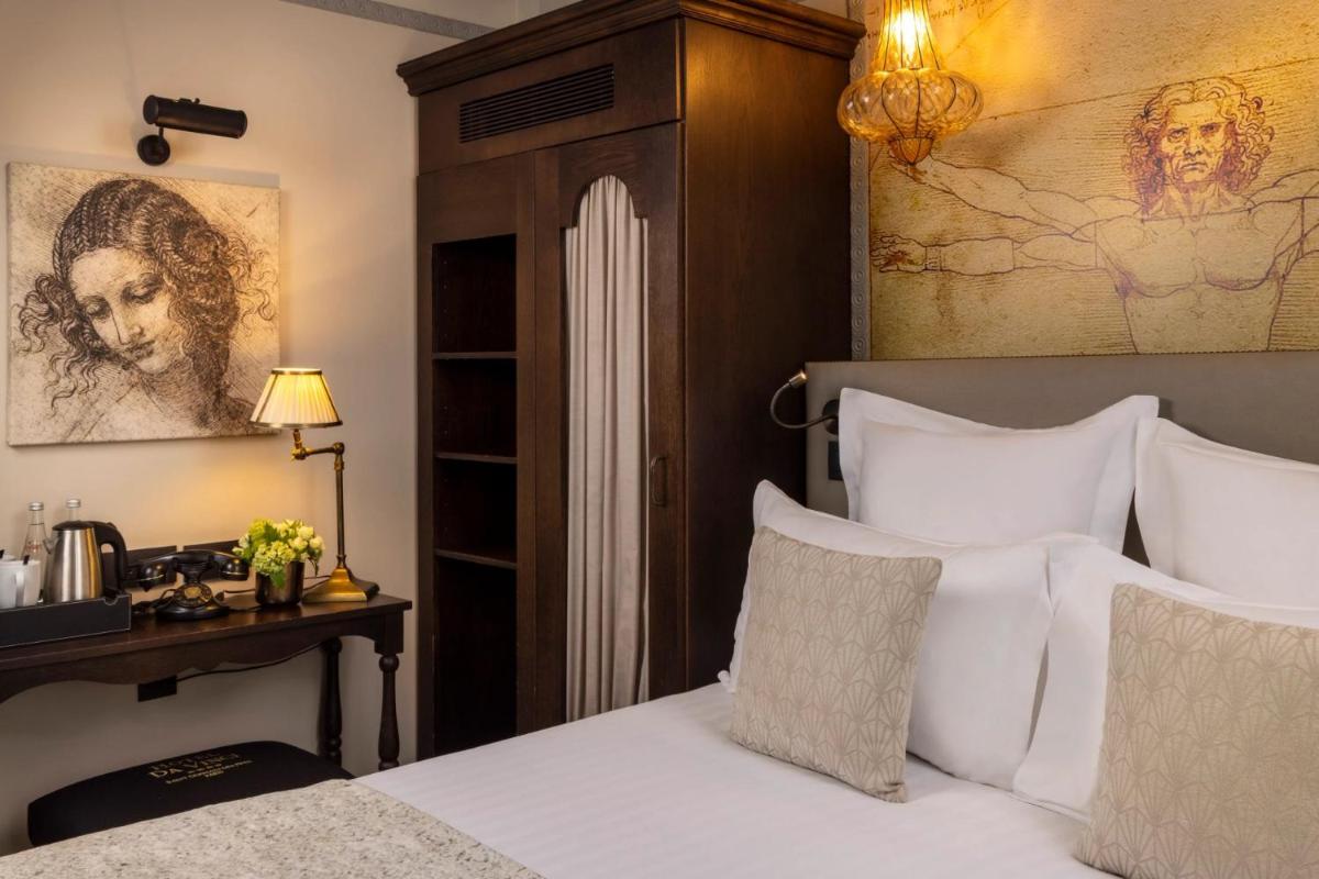 Un ou plusieurs lits dans un hébergement de l'établissement Hôtel Da Vinci & Spa