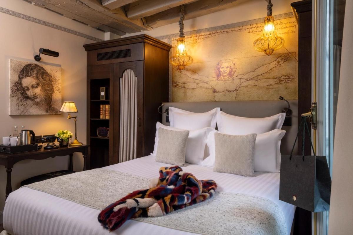 Un ou plusieurs lits dans un hébergement de l'établissement Hôtel Da Vinci & Spa