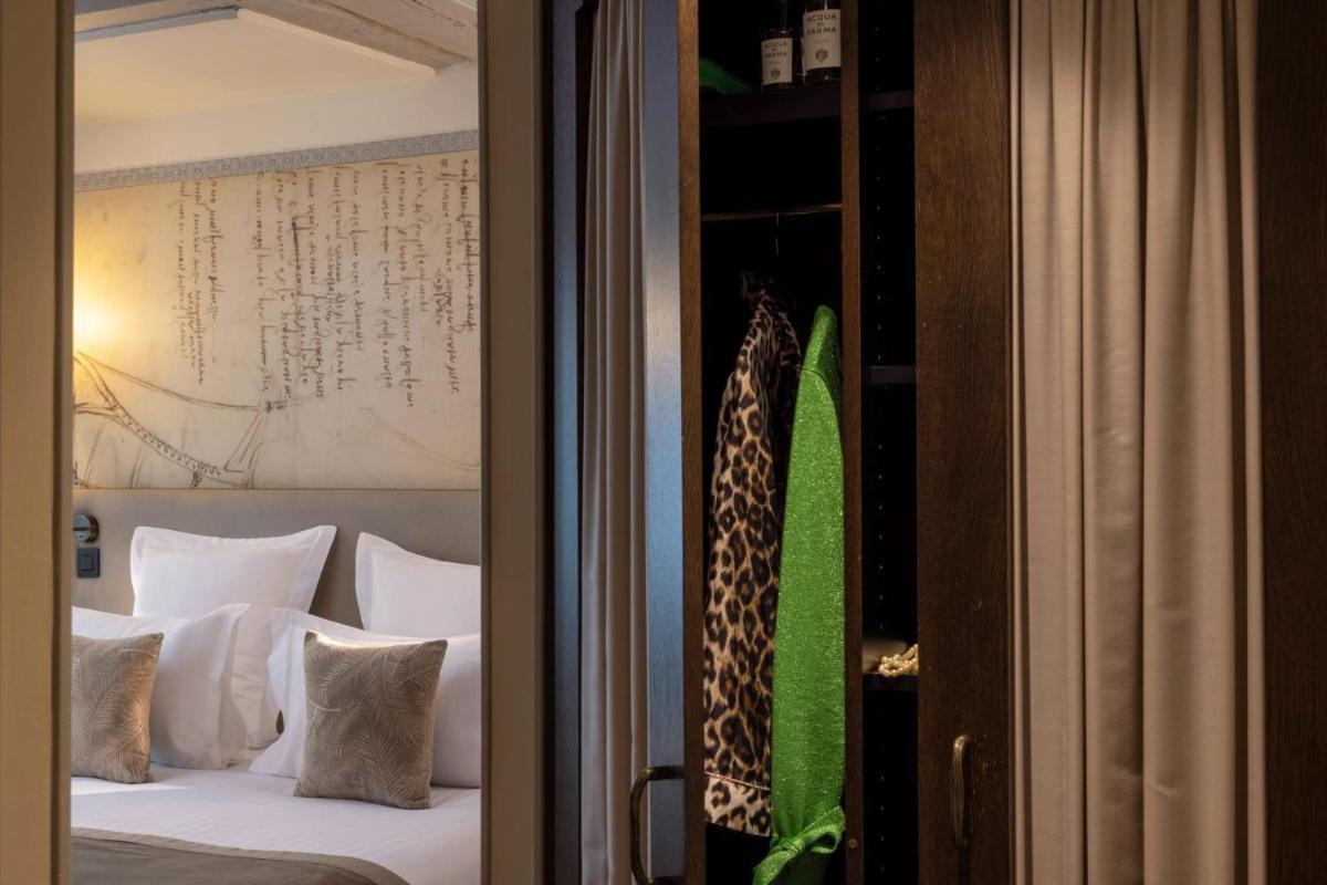 Un ou plusieurs lits dans un hébergement de l'établissement Hôtel Da Vinci & Spa