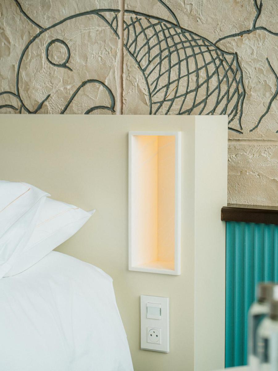 Un ou plusieurs lits dans un hébergement de l'établissement Hotel Atlantic