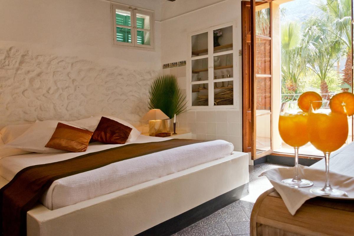 Cama o camas de una habitación en Hotel Can Roses