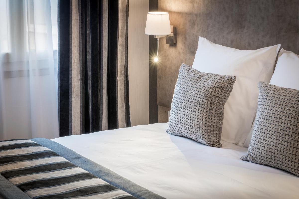 Un ou plusieurs lits dans un hébergement de l'établissement Hôtel Le Rive Droite & SPA