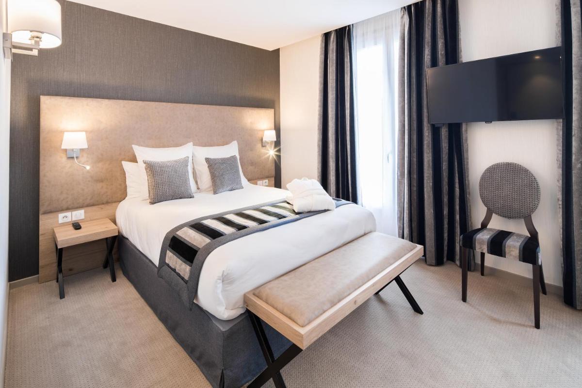 Un ou plusieurs lits dans un hébergement de l'établissement Hôtel Le Rive Droite & SPA