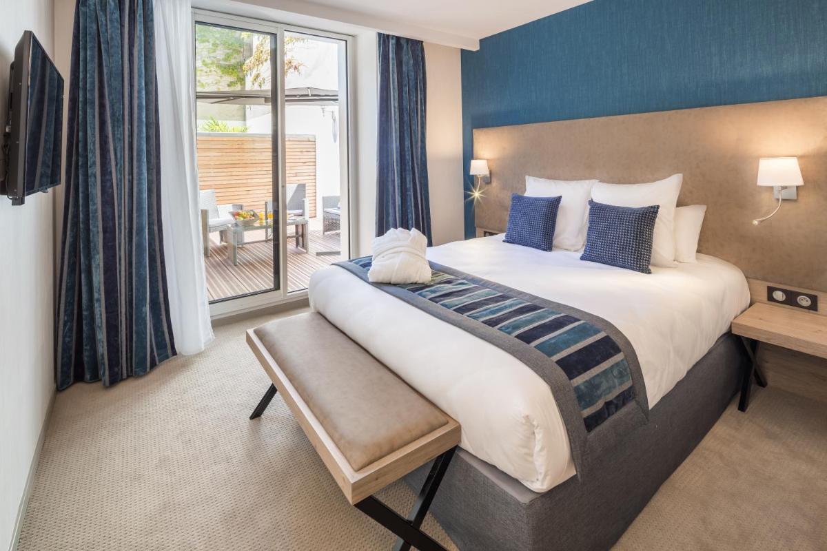 Un ou plusieurs lits dans un hébergement de l'établissement Hôtel Le Rive Droite & SPA