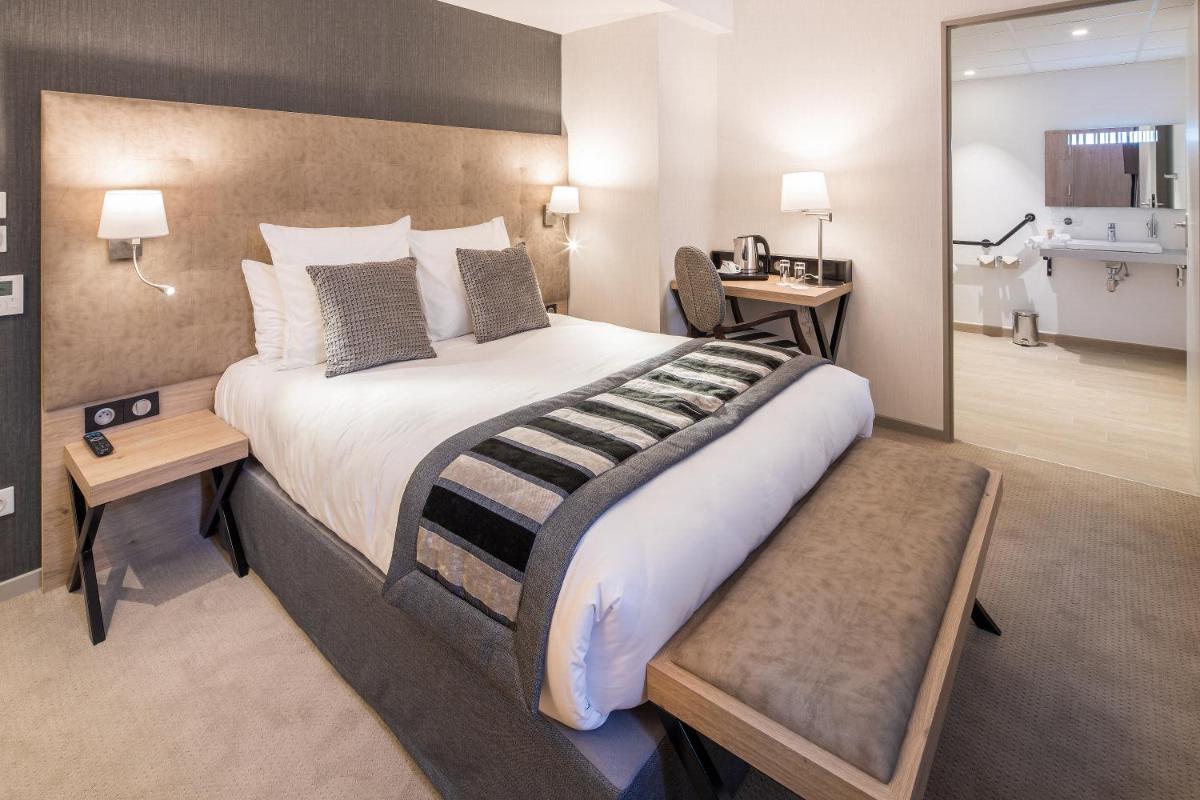 Un ou plusieurs lits dans un hébergement de l'établissement Hôtel Le Rive Droite & SPA