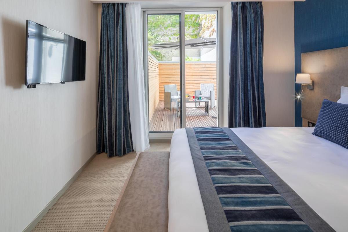 Un ou plusieurs lits dans un hébergement de l'établissement Hôtel Le Rive Droite & SPA