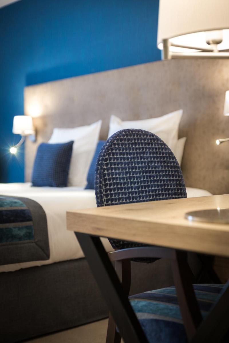 Un ou plusieurs lits dans un hébergement de l'établissement Hôtel Le Rive Droite & SPA