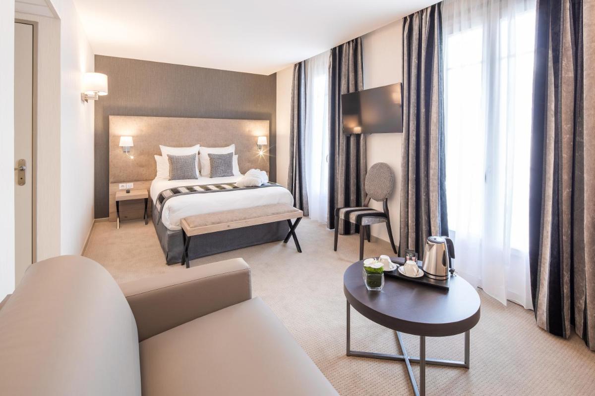 Un ou plusieurs lits dans un hébergement de l'établissement Hôtel Le Rive Droite & SPA