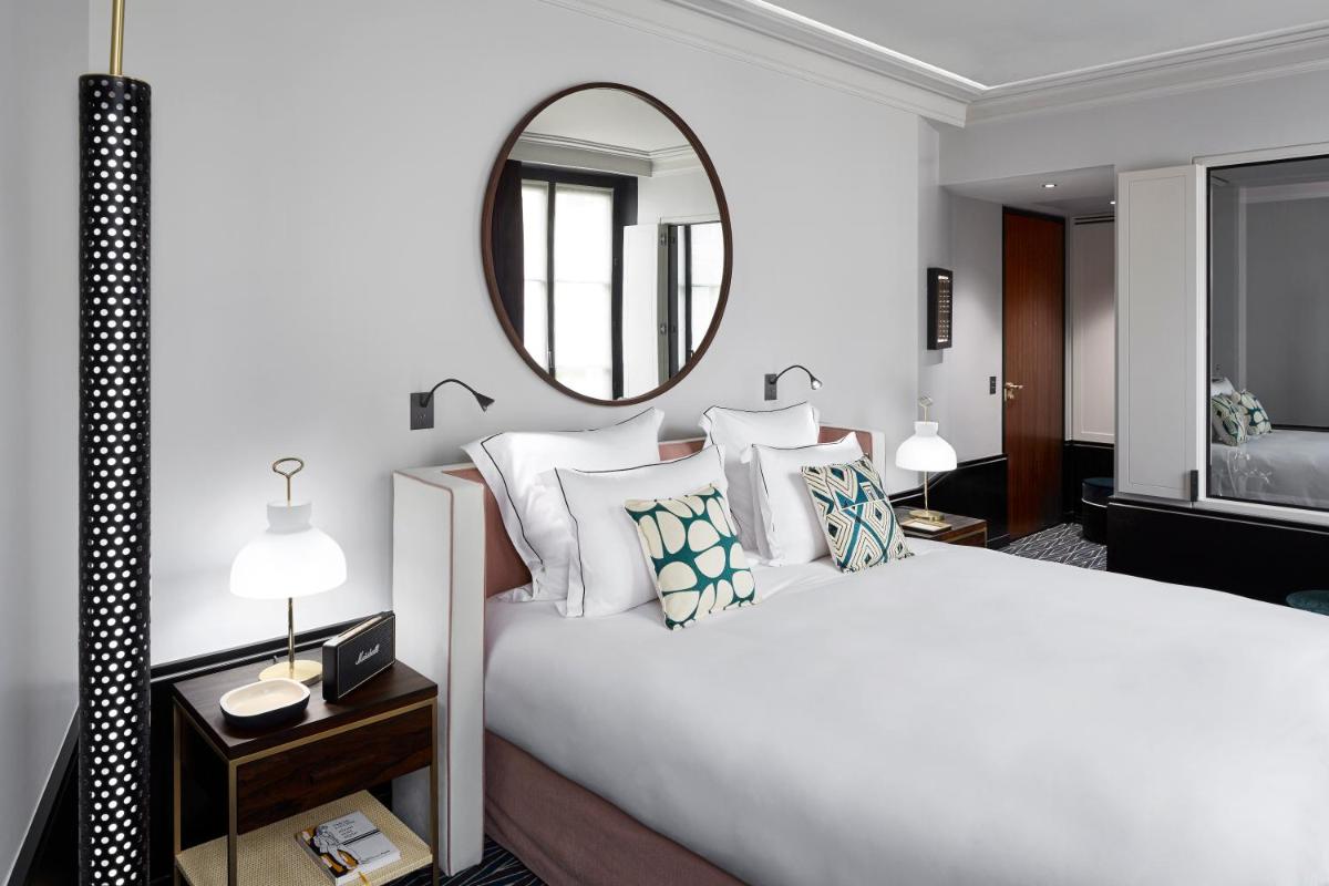 Un ou plusieurs lits dans un hébergement de l'établissement Le Roch Hotel & Spa