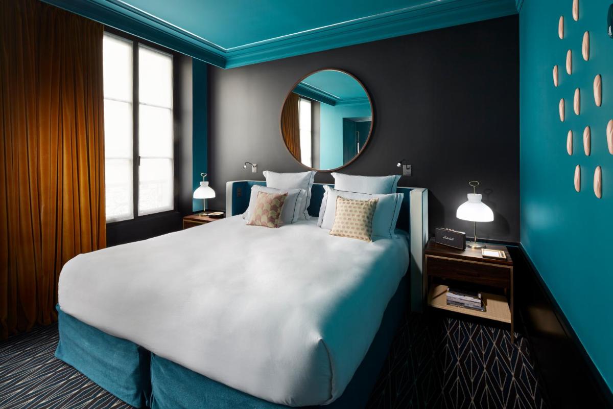 Un ou plusieurs lits dans un hébergement de l'établissement Le Roch Hotel & Spa