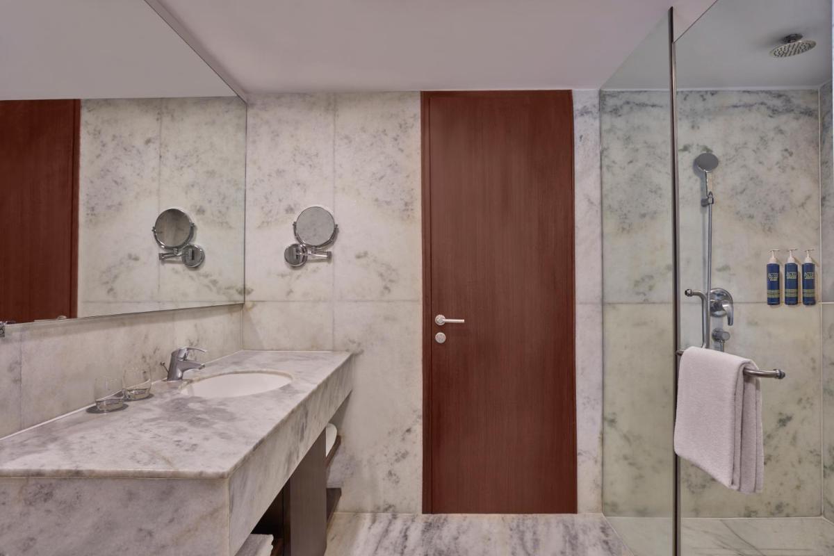 a bathroom with a sink and a shower at Four Points by Sheraton Hotel and Serviced Apartments Pune in Pune
