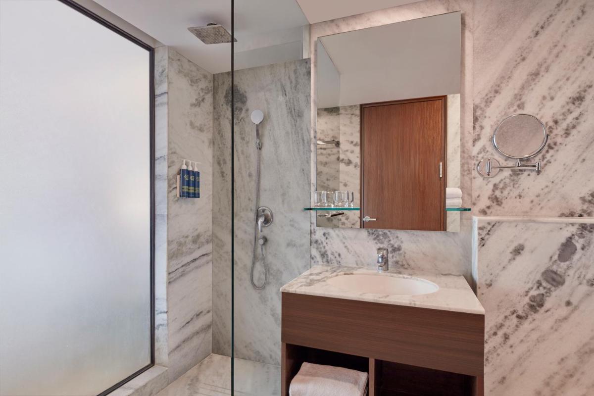 a bathroom with a sink and a shower at Four Points by Sheraton Hotel and Serviced Apartments Pune in Pune