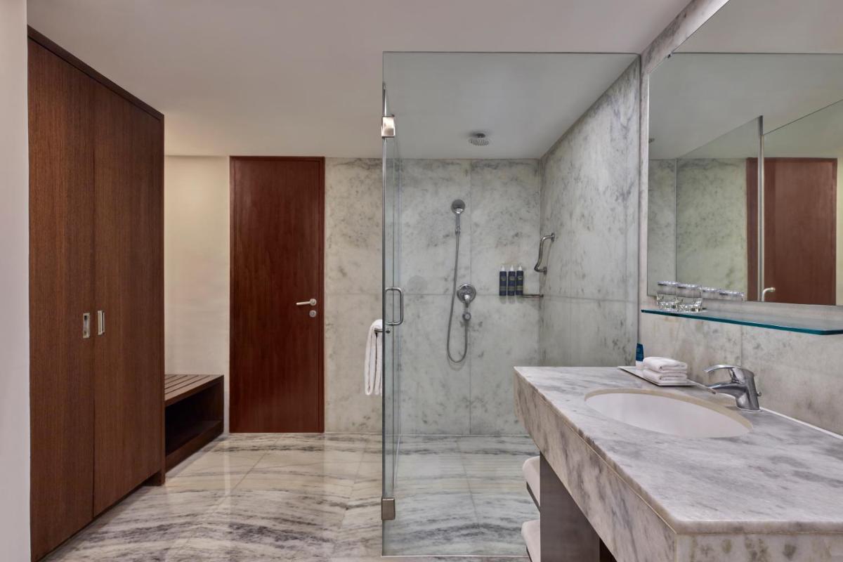 a bathroom with a sink and a shower at Four Points by Sheraton Hotel and Serviced Apartments Pune in Pune