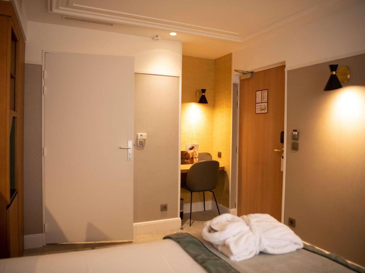 Un ou plusieurs lits dans un hébergement de l'établissement Mercure Paris Opera Garnier Hôtel & Spa