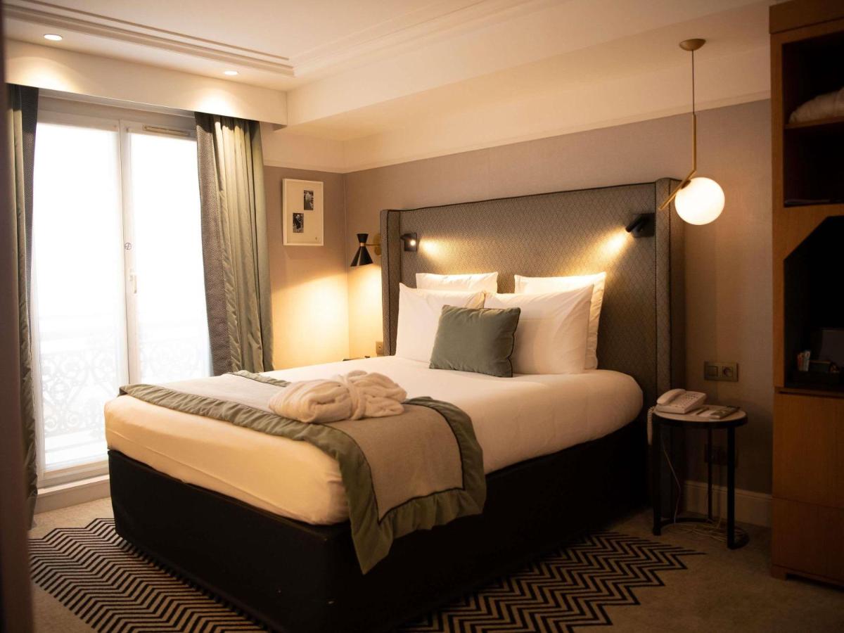 Un ou plusieurs lits dans un hébergement de l'établissement Mercure Paris Opera Garnier Hôtel & Spa