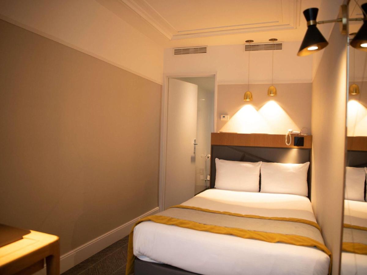 Un ou plusieurs lits dans un hébergement de l'établissement Mercure Paris Opera Garnier Hôtel & Spa
