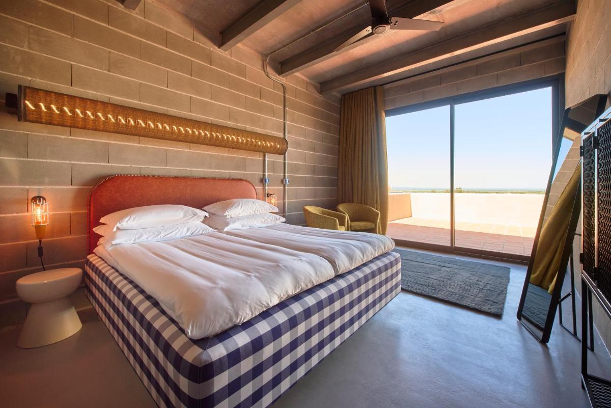 Uma cama ou camas num quarto em Moagem Industrial Lodge