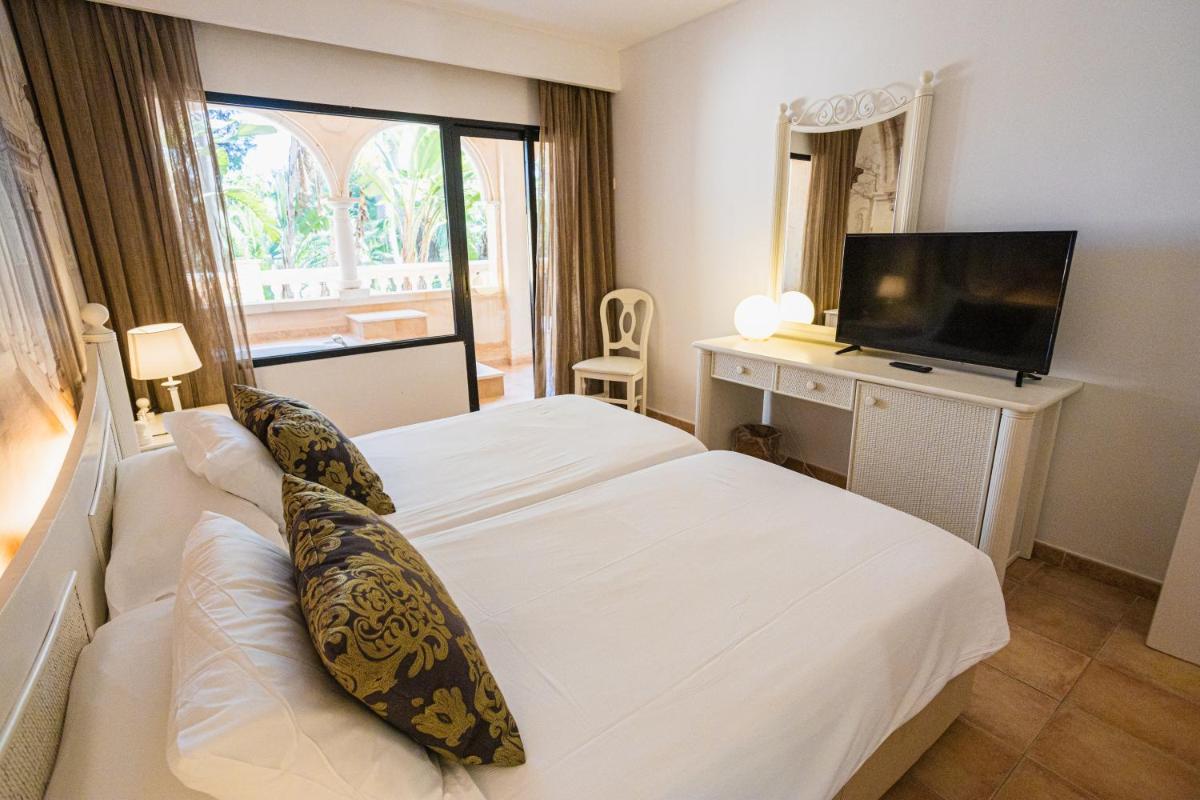 Cama o camas de una habitación en Lago Garden Apart-Suites & Spa Hotel