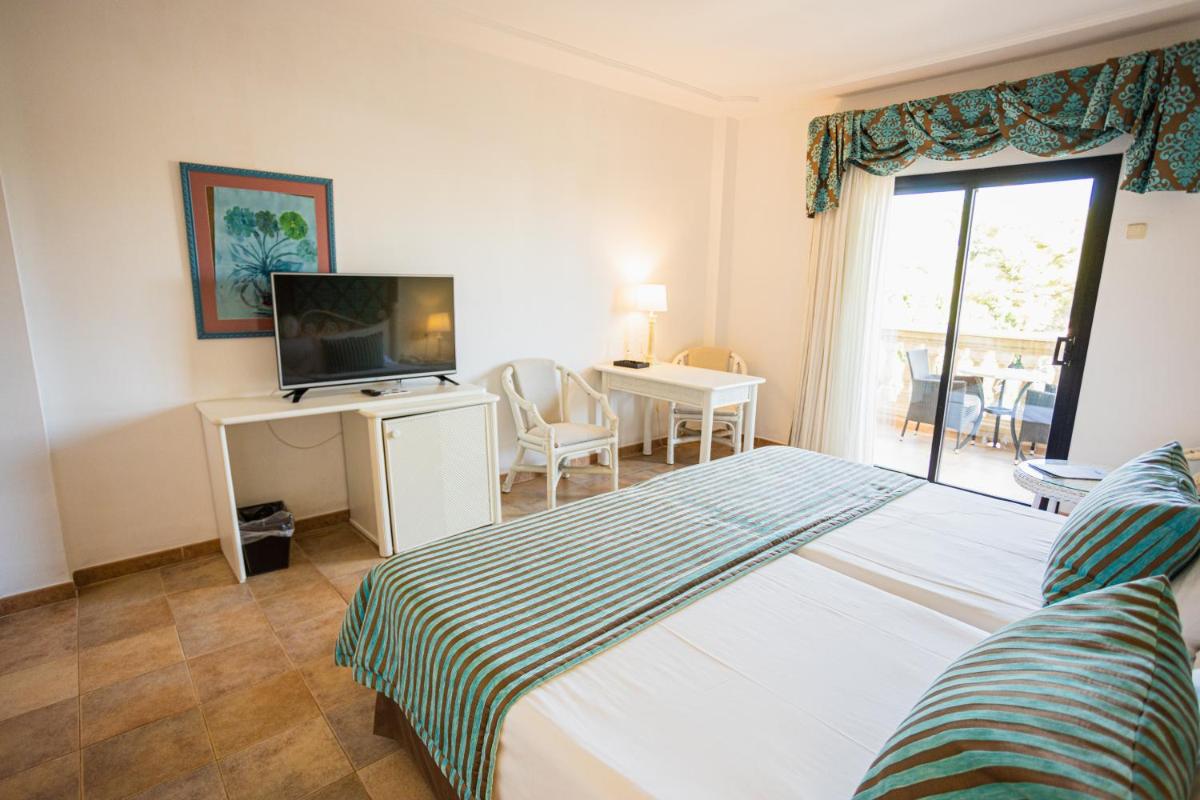 Cama o camas de una habitación en Lago Garden Apart-Suites & Spa Hotel