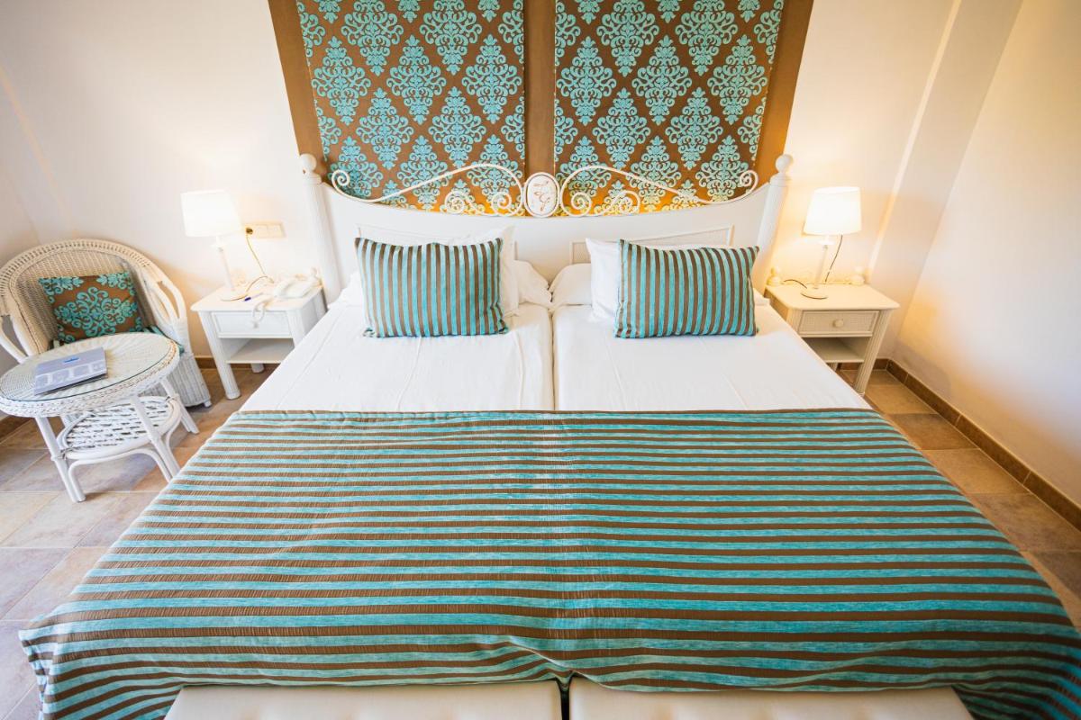 Cama o camas de una habitación en Lago Garden Apart-Suites & Spa Hotel