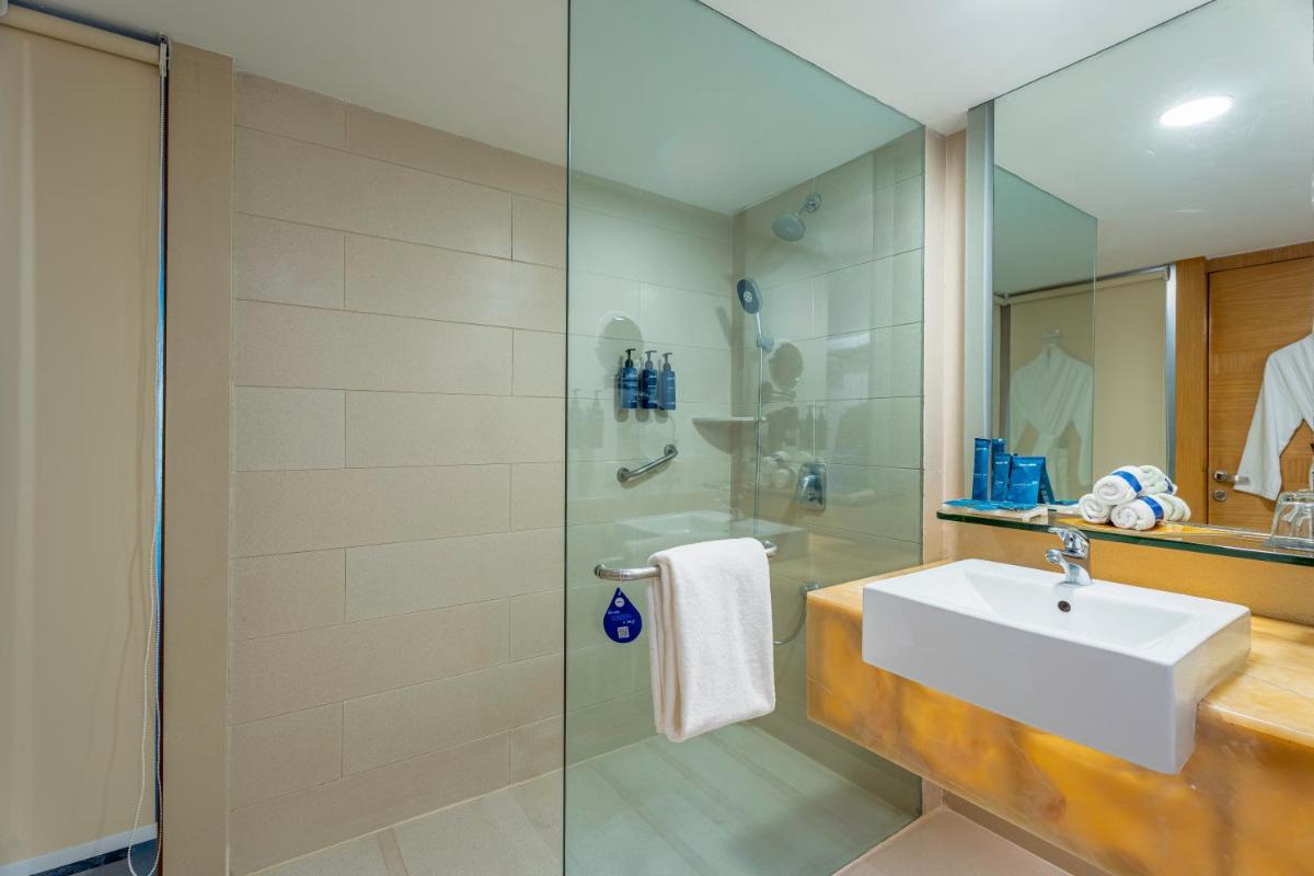 a bathroom with a sink and a shower at Radisson Blu Hotel Pune Kharadi in Pune