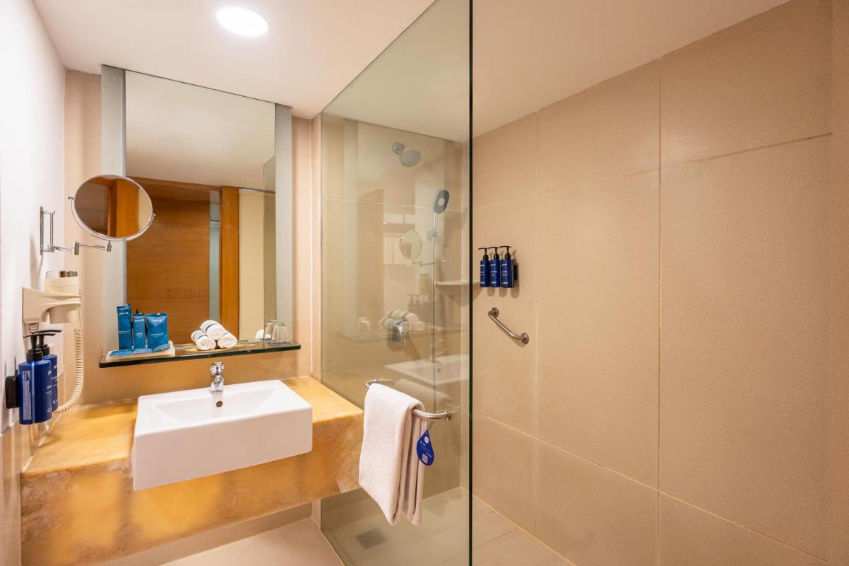 a bathroom with a sink and a shower at Radisson Blu Hotel Pune Kharadi in Pune