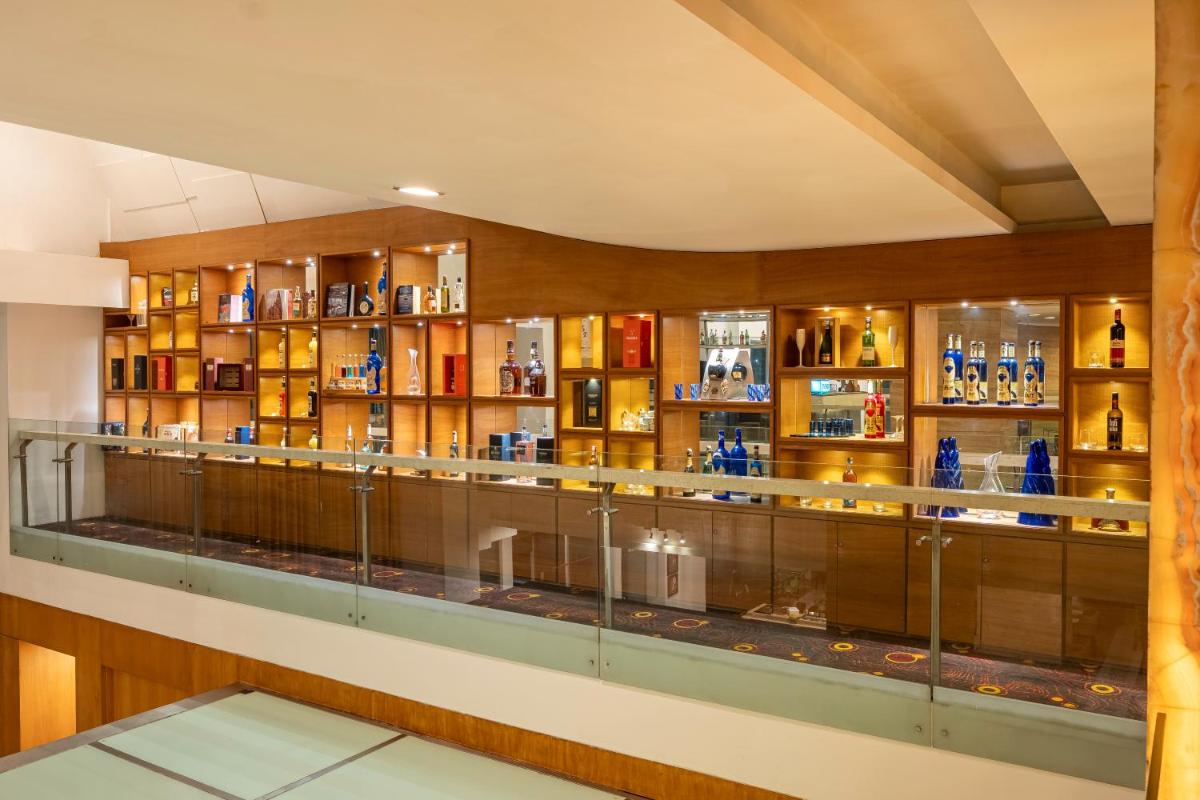 a display case in a room with alcohol bottles at Radisson Blu Hotel Pune Kharadi in Pune